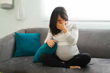 Depressed pregnant woman affected by hormones and crying