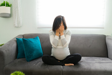Sad woman sobbing because of problems in her pregnancy