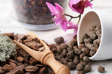 Pine bark, expanded clay and moss for planting orchids in a pot.