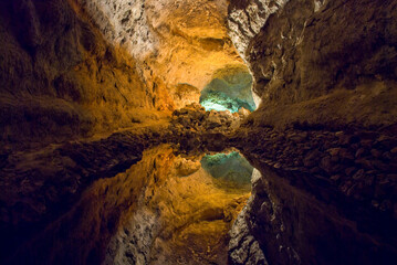 Fototapeta na wymiar Green Caves Cueva de los Verdes in Lanzarote underground lake beautiful reflections of rocks in water