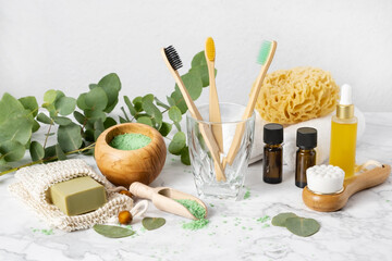 Eco-friendly bathroom accessories: bamboo toothbrush, sea sponge, natural soap in organic saver bag...