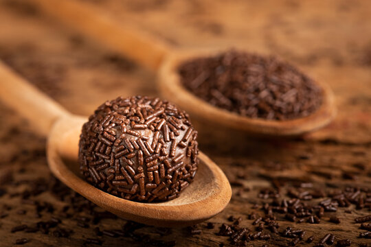 Chocolate brigadeiro in wooden spoon. Brigadeiro, traditional Brazilian sweet.