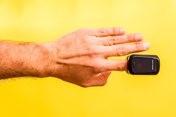 An adult is monitored for oxygen saturation and pulse with a homemade oximeter, isolated on a...