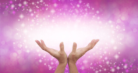 Connecting to High Frequency Magenta Universal Healing Energy - female cupped hands reaching up into a beautiful white light against a pink energy field background with sparkles and white light 
