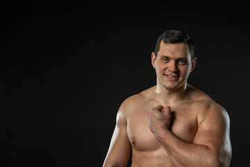 Fototapeta premium Fitness man in red panties confident adult attractive athlete isolated. Elegant boy, fashionable lonely black bodybuilder background