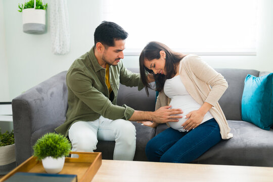 Distressed pregnant woman having contractions at home