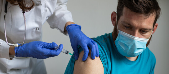 man in risk group getting coronavirus vaccine