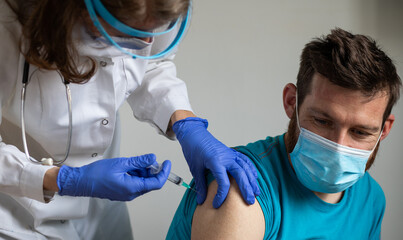 man in risk group getting coronavirus vaccine