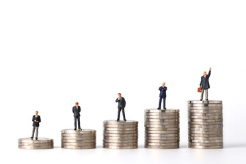 Miniature people: businessman standing stacking coins podium No.1, 2, 3, 4 and 5 isolated white background (Financial and Business competition concept)