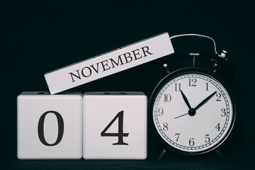 Important date and event on a black and white calendar. Cube date and month, day 4 November. Autumn season.
