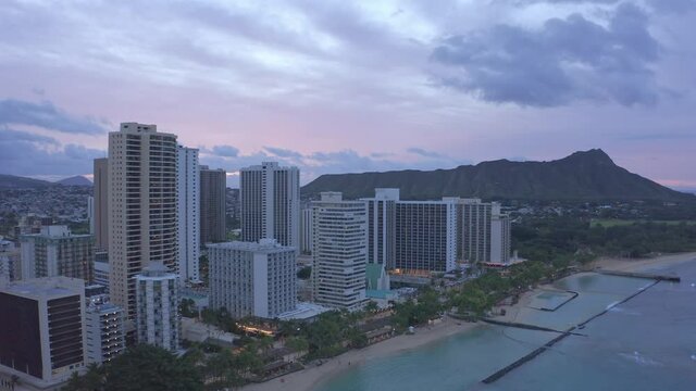 Aerial Establishing Dolly shot of Hotels on Waikiki Beach at sunrise in Downtown Honolulu Hawaii on O'ahu, USA beach hotels hawaii