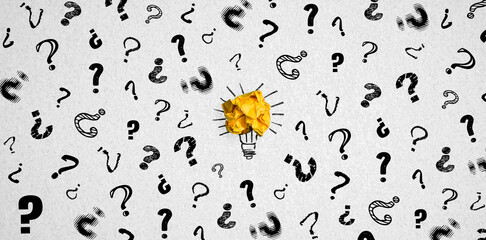 many question marks surrounding a paper ball symbolizing a lightbulb and idea on paper background