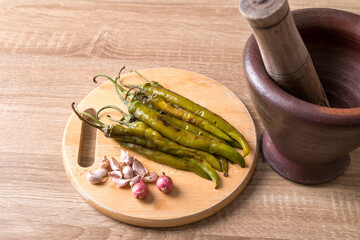 Northern Thai food (Nam Prik Num), Grilled green chili pepper with garlic and shallot pounding in mortar