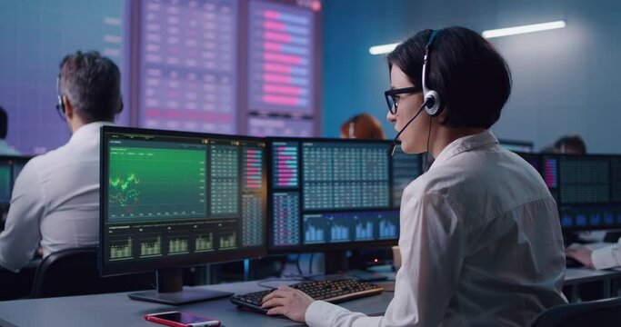 Young woman trading stocks in office