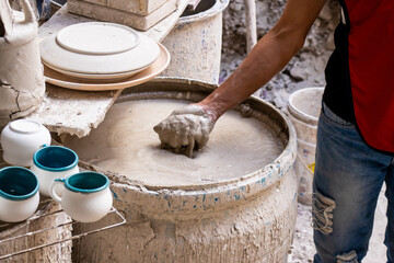 Barrel filled with mix for the clay injection molding technique in a traditional ceramics factory at the small city of Raquira in Colombia