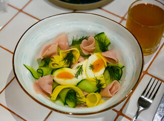 Appetizing salad with ham, cucumbers and boiled egg