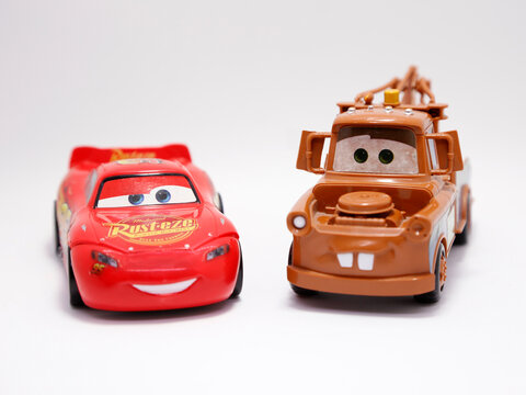  Cars. Lightning MCQUEEN and Crane Mate. Toy car for Children. Tow Mate Mater. Pixar Cars movie. Red car. Number 95. Rust-eze. Isolated white. Front view.