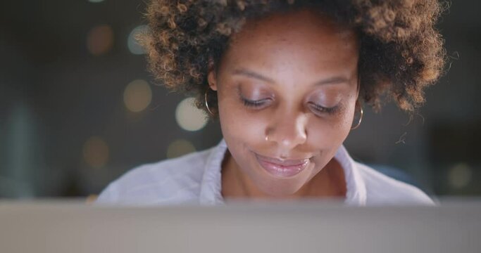 Concentrated young african businesswoman using laptop in office.
