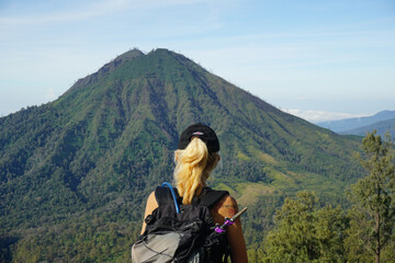 Fototapeta na wymiar A Woman Walking Down From the top of Mount Ijen Banyuwangi Indonesia.