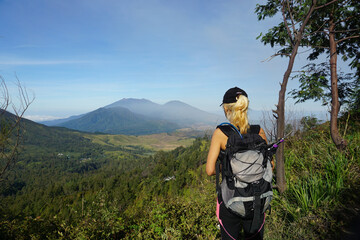 Fototapeta na wymiar A Woman Walking Down From the top of Mount Ijen Banyuwangi Indonesia.