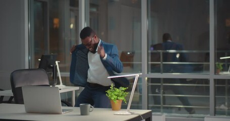 Funny happy afro-american male employee dancing in office