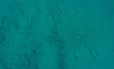 rough teal green concrete or cement surface background with space for text. architecturural wall or facade background. abstract interior laminated material background.
