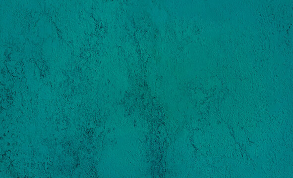 rough teal green concrete or cement surface background with space for text. architecturural wall or facade background. abstract interior laminated material background.