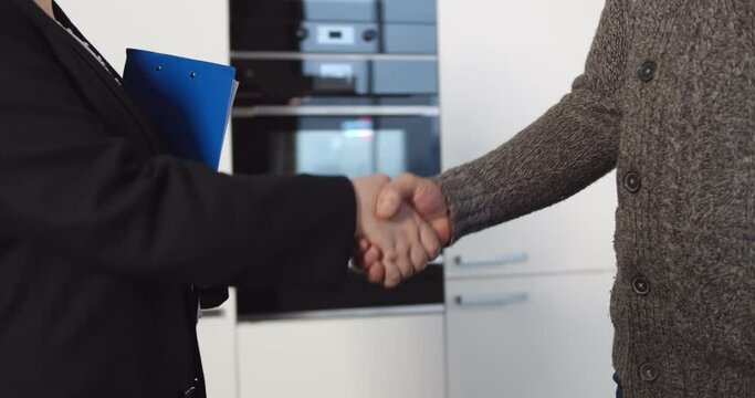Real estate agents and buyer handshake after signing business contract