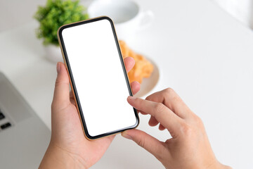 female hands holding phone with isolated screen in the coffee shop