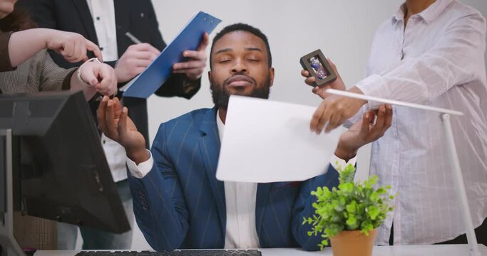 Calm young businessman meditate at business meeting avoiding pressure of annoying angry colleagues.