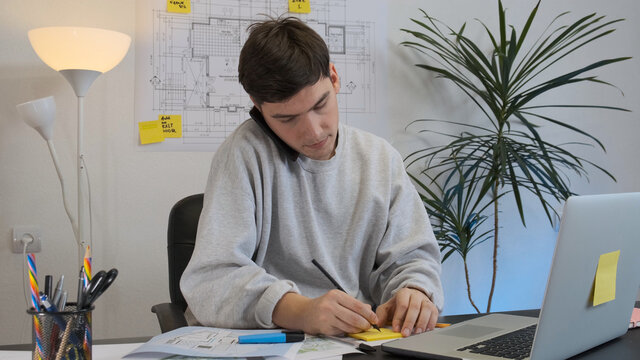 A businessman works from his home office during a pandemic. Engineer architect.