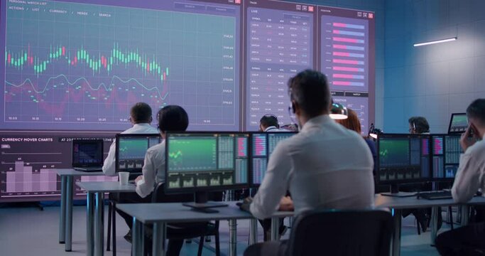 Male trader using computer to trade stocks