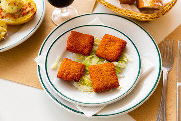San Jacobo steak filled with cheese and ham on restaurant table