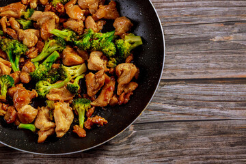 Stir fry with chicken and broccoli on wok. Chinese food.