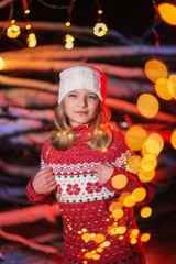 girl model holding a luminous garland in her hands