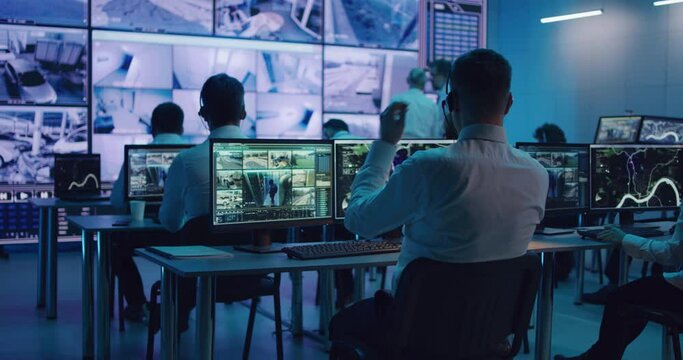 Male spy browsing video and map on computers