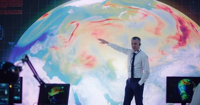 Male leader showing Earth simulation and instructing team of ecologist