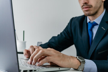 man in suit typing on computer, freelancer