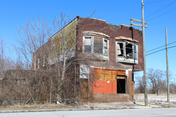 Abandoned brick retail store with apartments above in Detroit's Poletown neighborhood