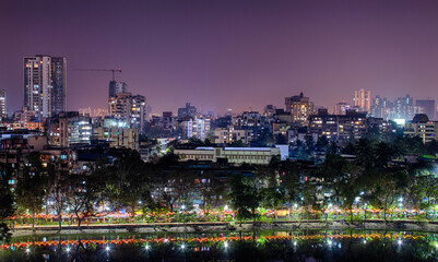 Fototapeta na wymiar View Of City Lit Up At Night