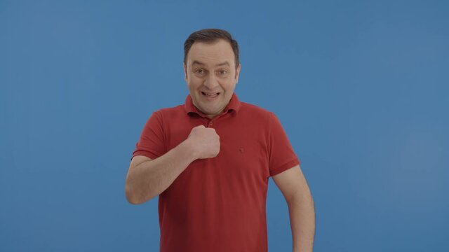 This is me! Proud, egotistical, confident young man pointing at himself.Proud, egoistic confident young man in red ti shirt, pointing at himself and looking arrogant. 