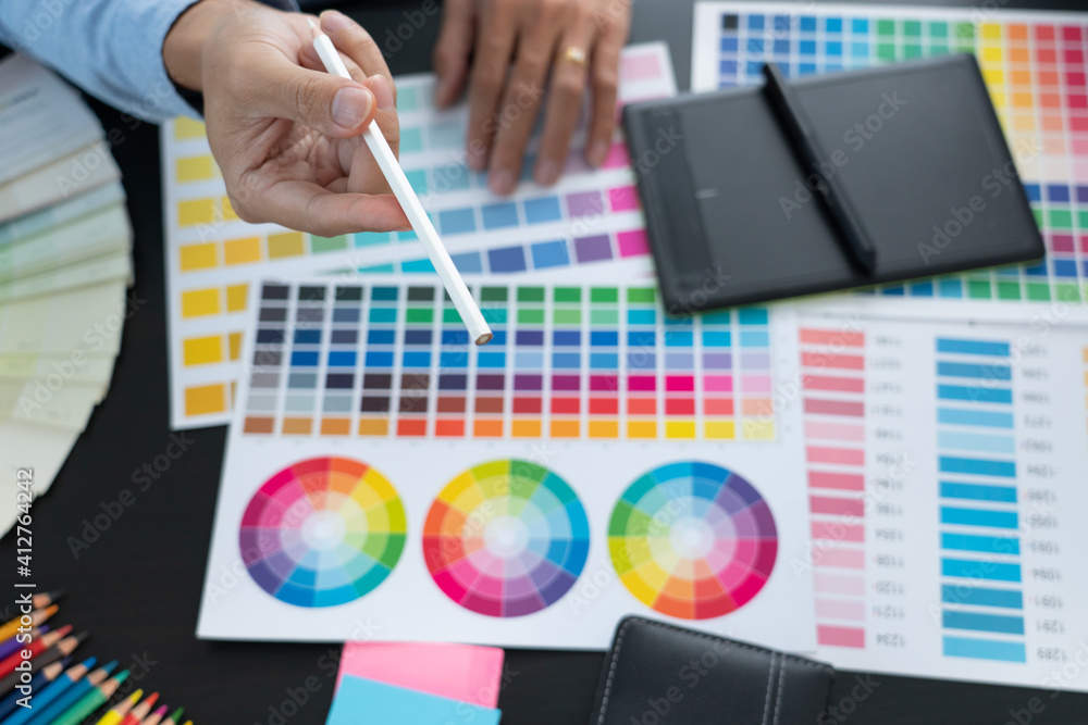 Aufkleber graphic designer or creative working together coloring using graphics tablet and a stylus at desk wi