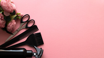 Womens day, layout of hairdressing tools on pink background with flowers, flat lay, top view. Spring Festival for a hairdresser