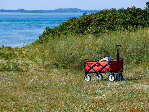 Red beach cart trolley by the sea shore