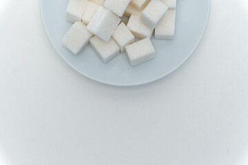refined sugar sweets calories on a plate light background