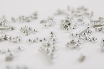 iron screws and nuts on a white background for repair and construction
