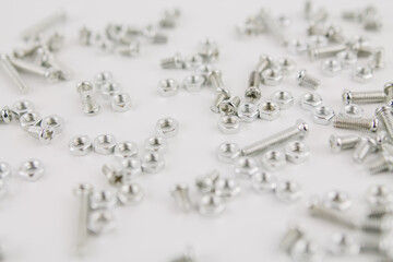 iron screws and nuts on a white background for repair and construction