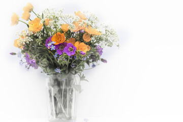 bouquet of wild flowers in a glass vase