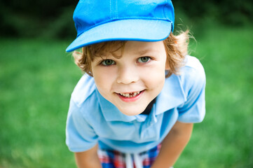 Portrait of cute preschooler boy in blue cap.