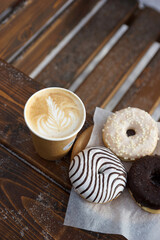 Street food and coffee on a wooden table in the street in winter